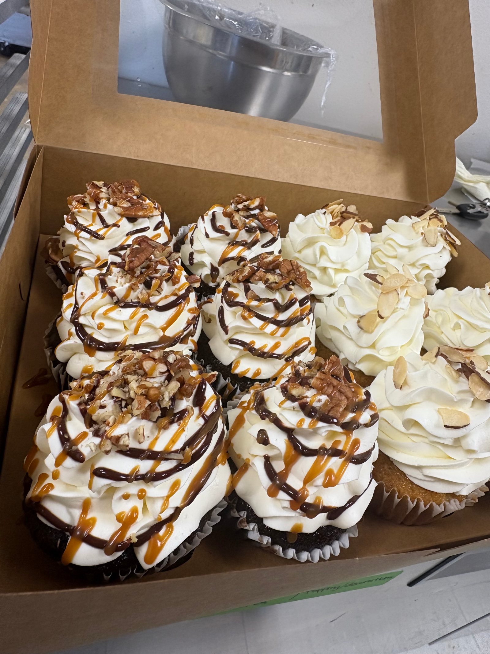 Cupcakes topped with caramel, chocolate and nuts