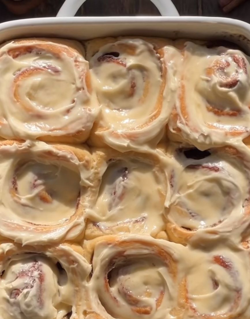A tray of freshly glazed cinnamon rolls
