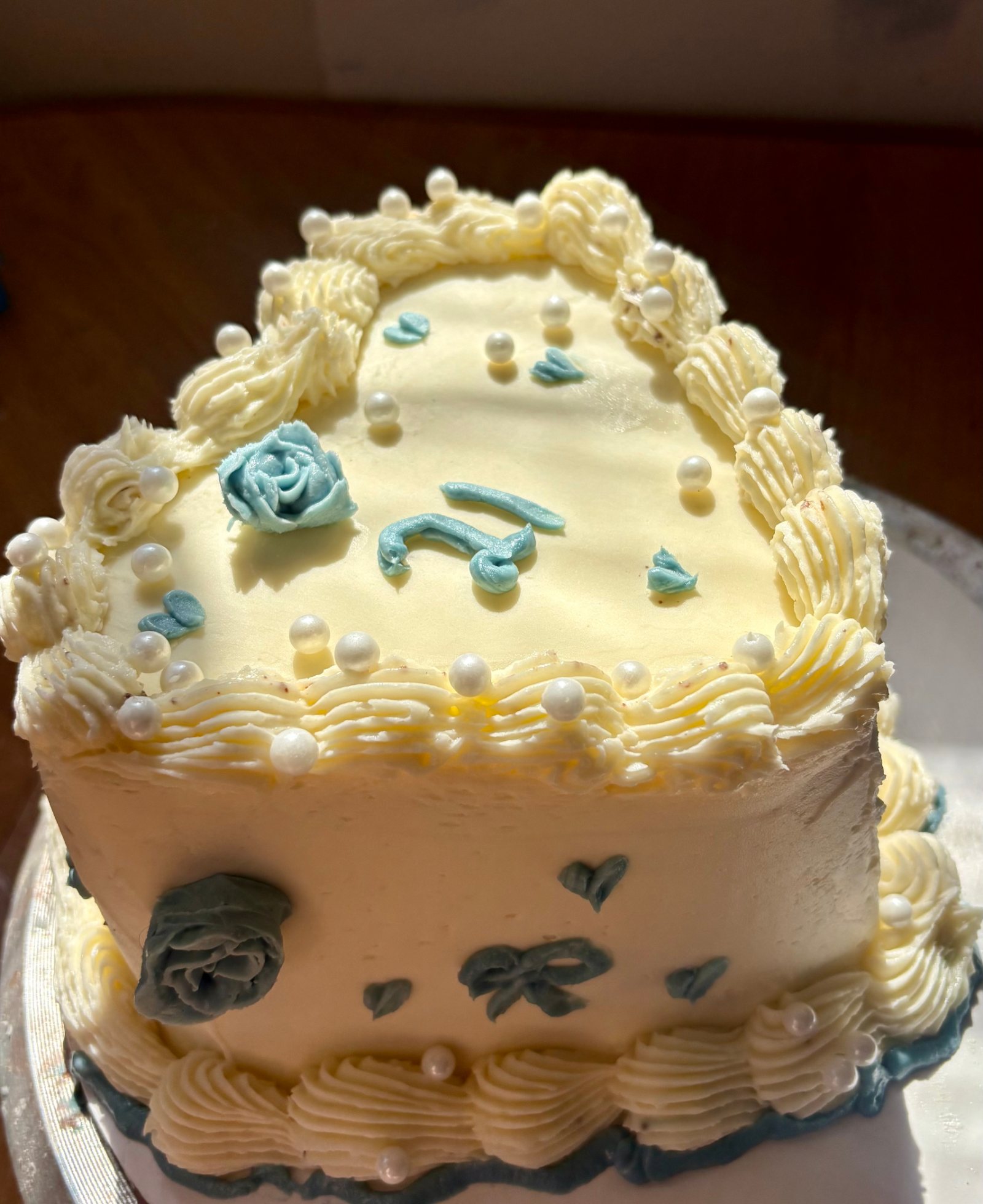 Heart-shaped white and blue 21st birthday cake