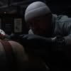 Derek Neal working on a tattoo