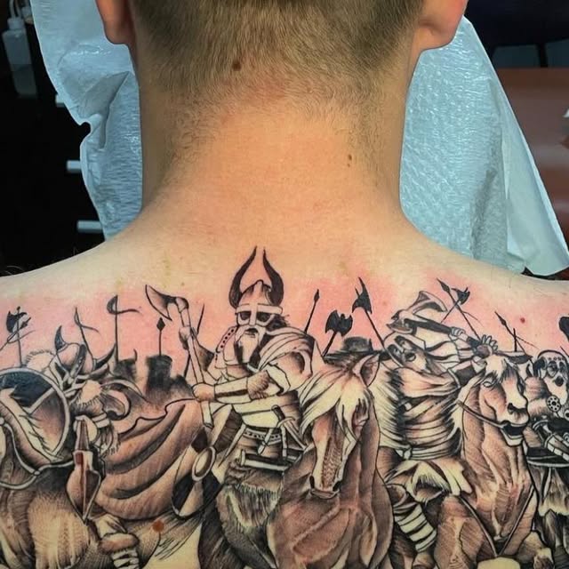 Large illustrative battle scene back tattoo by Ryan Worley